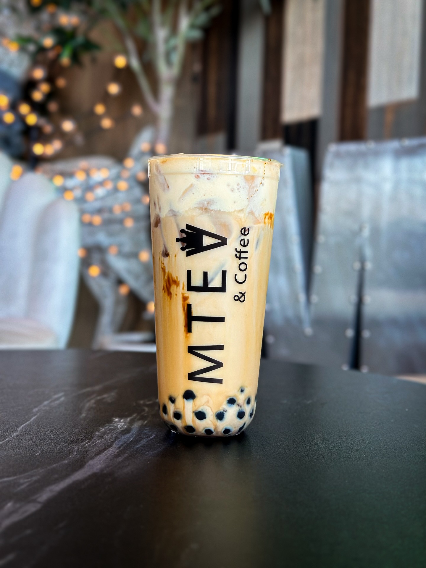 Brown Sugar Milk Tea served in a clear cup, with caramelized brown sugar swirls and tapioca pearls at the bottom.